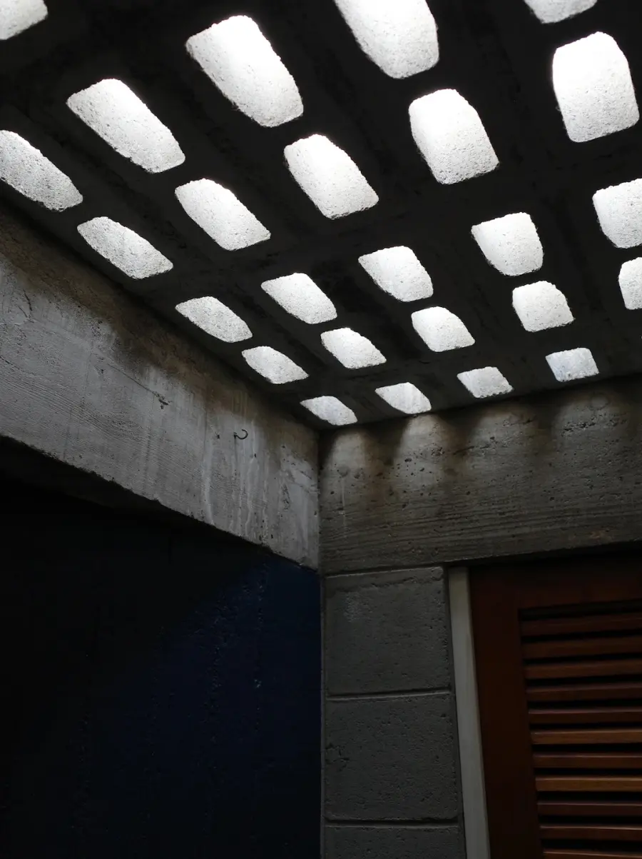 Daylight through a grid of openings in a concrete ceiling